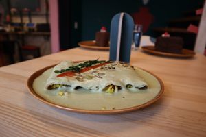 PAPADZULES: Tortillas de maíz criollo nixtamalizado rellenas de huevo de tofu con salsa tradicional de pepita, jitomate martajado al orégano, epazote frito y pepitas tostadas.  at Pali Pali del Valle in Mexico City