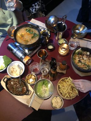 Iron pot 'shared earth' (spicy), vegan no-mince meat  bulgogi w sides included, vegan fries w veganese, last dish unknown. makoli, seoul soul ale & water (162.50 chf)  at Miss Miu - Europaallee in Zurich