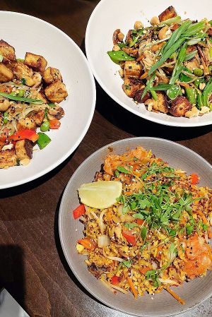 Korean fried rice and two noddle bowls with tofu at Harvest Seasonal Grill & Wine Bar in Newtown