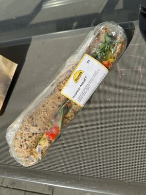 Sandwich houmous avocat en pain gris.  at Panos in Mons