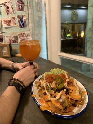 loaded vegan nachos with chili sin carne, guacamole and vegan cheddar  at Monchito in Barcelona