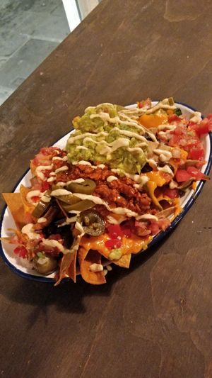 Nachos with guacamol, vegan cheddar and vegan bolognese at Monchito in Barcelona