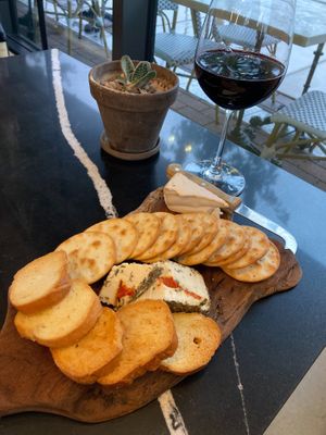 Happy hour cheese board and house red wine at Rebel Cheese in Austin
