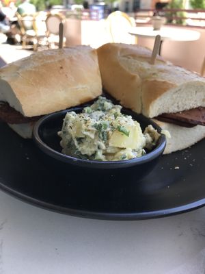 Bacon, Brie, me & potato salad. Has a lot of sweetness from the fig jam.   at Rebel Cheese in Austin