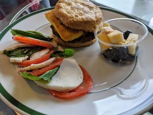 Breakfast menu (replated takeaway) Meatless Miracle and 1/2 a Caprese salad. at Rebel Cheese in Austin