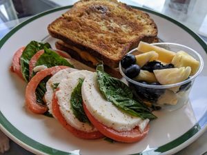 Breakfast menu (replated takeaway) Pesto Egg-O gluten-free option and 1/2 a Caprese salad. at Rebel Cheese in Austin
