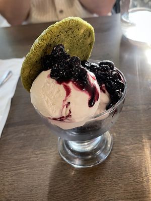 Coconut ice cream, berry compote, matcha and white chocolate cookie  at Vegivores in Reading