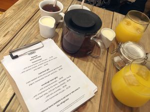 Menu, tea and orange juice  at Vegivores in Reading