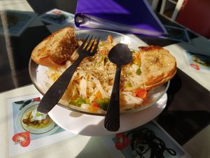 vegan herb rice noodle pasta with garlic, herbs, olive oil and bread at Aum Cafe in Varanasi