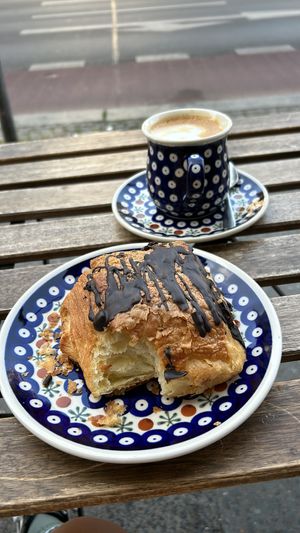 Yummy chocolate filled croissant and oat cappuccino   at Vollkornbäckerei Hartwich in Berlin