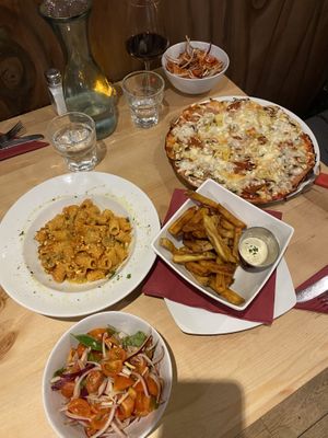 Pizza , pasta and homemade chips with a tomato side salad.   at Sora Lella Roman Vegan Restaurant in Edinburgh
