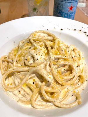 BUCCATINI CACIO E PEPE - classic Roman pasta recipe made with parmesan, black pepper and truffle sauce. at Sora Lella Roman Vegan Restaurant in Edinburgh