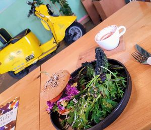 The Barefoot Burger: cup, book, and scooter for size still don't offer clear enough perspective. This burger is big and the plate is huge. at Barefoot Eatery in Christchurch