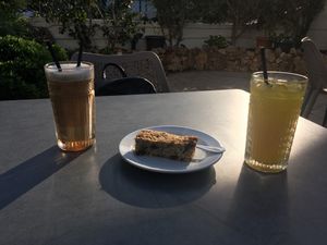 Ice latte with oat milk, orange juice and flapjack  at Al-Gharb Coffee Roasters in Albufeira
