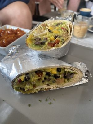 Veggie delight burrito with vegan cheese and tomato relish (oatly cold brew latte in background!)  at Al-Gharb Coffee Roasters in Albufeira
