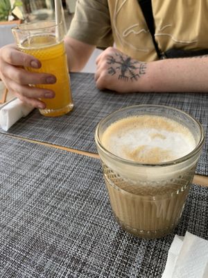 Fresh orange juice and latte macchiato with oat milk and salted caramel syrup   at Al-Gharb Coffee Roasters in Albufeira