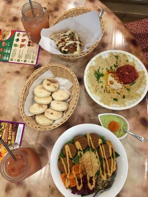 Falafel salad, hummus bowl, falafel pita and guava juice! Notice the reusable steel straws!  at Falafel Brothers - Shibuya in Tokyo