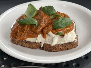 Toast with heirloom tomatoes, cashew creme, harissa, and basil  at Williams Eatery in Auckland
