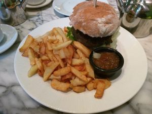 Black bean burger with sweet chilli sauce and vegan cheese served with chippy-style chips and homemade Welsh chutney at Alpine Coffee Shop and Gallery in Betws-y-coed
