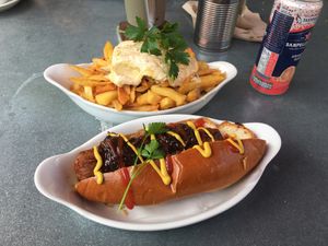 Vegan hotdog and hummus topped homemade chips with tahini   at Alpine Coffee Shop and Gallery in Betws-y-coed