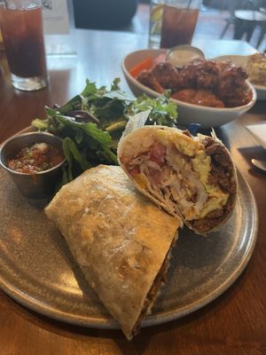 Sausage, egg and potato burrito. Buffalo cauliflower in the middle and mac & yeaze in the back. Bloody Marys were also delicious!  at Plum Bistro in Seattle