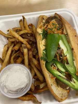 Blazing banh mi sandwich with fries  at Plum Bistro in Seattle