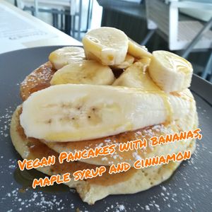 Vegan pancakes with bananas, maple syrup and cinnamon. at Estrella in Paphos