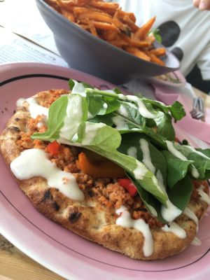 Vegan pizza: flatbread with soya mince, mixed caramelized bell peppers, fresh rocket salad and vegan sour cream at Estrella in Paphos