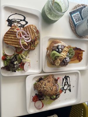 Vegan Pancakes with fruit and agave, Vegan Avocado & Veggie Triassant served with salad mix and veggies and a peppers & guacamole grilled sandwich with vegan cheese  at Calma Cafe in Gran Canaria