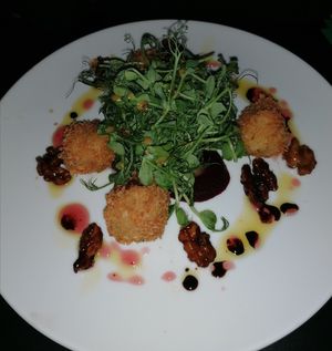 Feta bon bons, candied walnuts on cranberry coulis at Viridian in Bangor