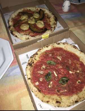 Pumpkin and cream cheese pizza and marinara sauce pizza at Squisito Pizzeria in Porto Alegre