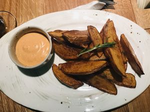 Fries accompanied by a delish sauce  at Mission in Moscow