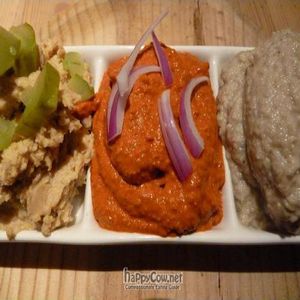 Hummus, red pepper with hazelnut, and babaganoush dips. at Birosta in Zaragoza