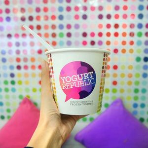 Yogurt cup in front of our signature wall at Yogurt Republic Ubud in Ubud
