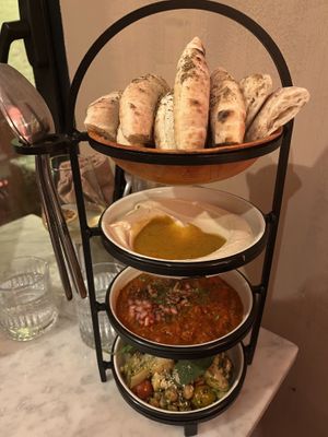 Mezze, salad, sourdough pita  at HUMM Restaurant in Antwerpen