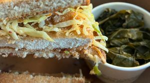 Vegan 'chicken' sandwich. sub multigrain bread toasted with collard greens at Busboys and Poets - Langston Lofts in Washington