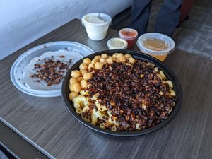 Koshari family size (barely enough for two hungry vegans😄tasty. Creamy garlic sauce was our favorite. at Koshari Mama in Somerville