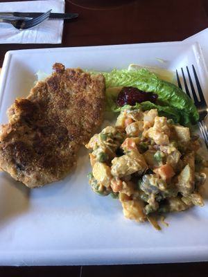 Schnitzel with potato salad and cranberry sauce  at Manna Kitchen in Lisle
