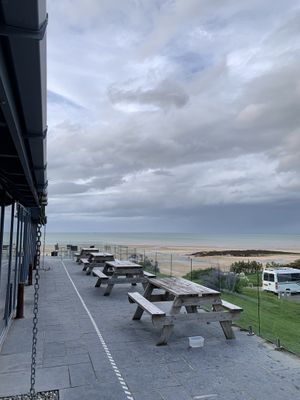 Outdoor seating (also around the back by the sea) at The Tavern on the Bay in Red Wharf Bay