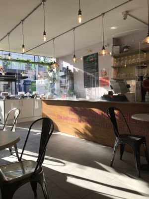 Till and cakes in the window  at The Guava Kitchen in South East London