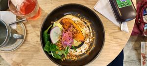 Scrambled tofu with turmeric, roasted pumpkin with fenugreek, arugula pesto, pickled red onions and mustard seeds, salty dukkah granola at the friendly kitchen in Paris