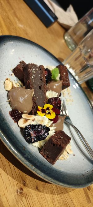  Plated dessert - 60% chocolate brownie

Vanilla and tonka bean whipped ganache, hazelnut cream, cherry, pralin at the friendly kitchen in Paris