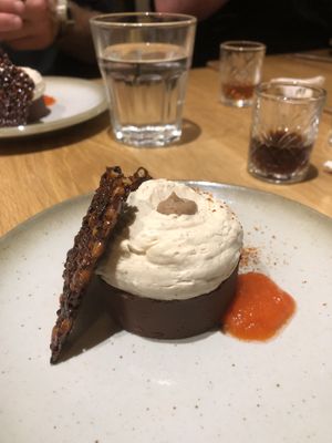 Chocolate fudge pudding with pepper coulis, cream and caramel wafer  at the friendly kitchen in Paris