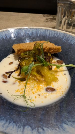 Almond velouté “ajo blanco” style

Shredded leeks preserved in chipotle pepper-infused oil and smoked salt, wild almonds, homemade focaccia tuile, pea shoots at the friendly kitchen in Paris