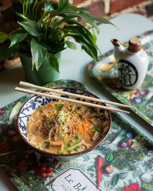 Magic Miso Soup - Quinoa noodles immersed in miso broth, green peas, "free-range" tofu, root veggies, alfalfa shoots and ginger velvet dressing at Le Botaniste - Bailli in Brussels