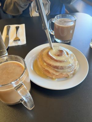 Coconut chai with a cinnamon roll to share   at Blossoming Lotus - Irvington in Portland