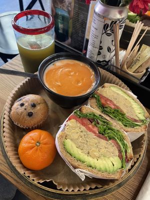 Chickpea and avocado sandwich with creamy tomato soup. Arrived as a whole meal with vegan blueberry muffin and orange    at UT47 Manhattan in New York City