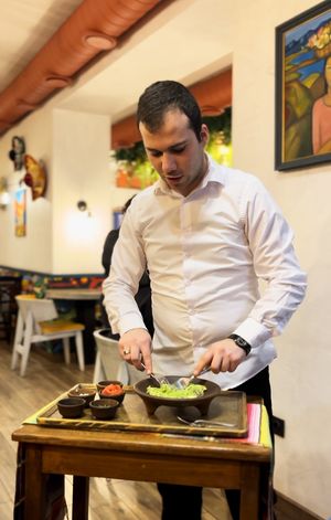 The server is making guacamole right in front of us! at Los Pueblos in Yerevan