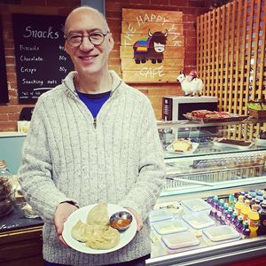 Our lovely Tim with his plate of Fresh Vegan Momo ! at The Happy Yak Cafe in Leeds