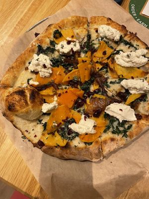 Seasonal vegan pizza with squash and vegan ricotta and cranberry  at True Food Kitchen in New Orleans